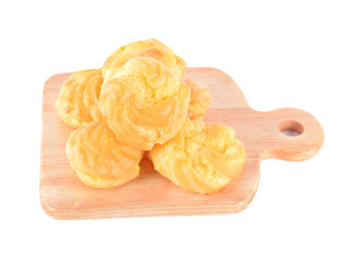 Cream puff with filling on wood isolated on white background