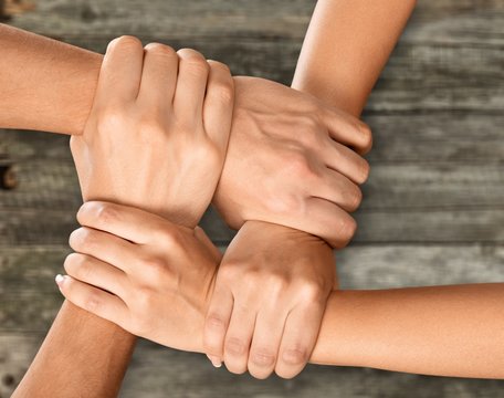 Group of people stacking hands together