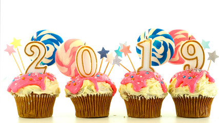 2019 Happy New Year's candy land lollipop drip cupcakes on white background.