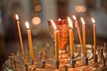 Candles in chandelier. Orthodox Church. bathing the into the baptismal font. Soft focus