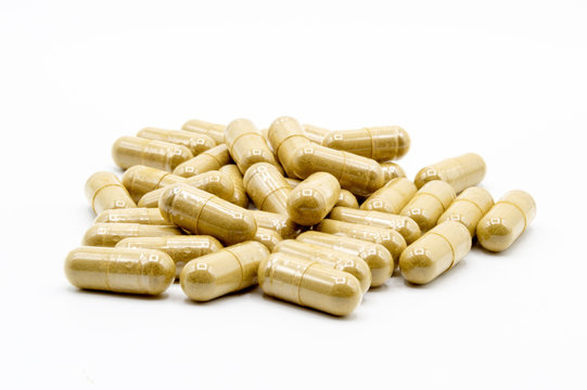 Isolated Kratom capsules on a white background