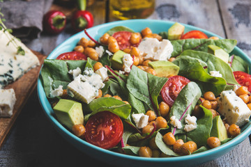 Healthy vegan salad with avocado ,beet leaves ,chickpea, broccoli ,tomato,blue cheese