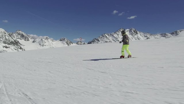 Snowboarder on the slope in slow motion