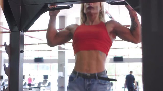 Fit woman doing pull ups exercise