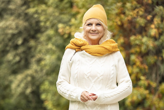 Senior Woman In Autumn Park.