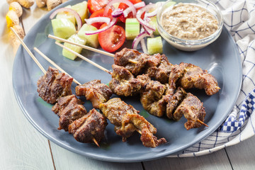 Traditional pork satay with peanut sauce and vegetables