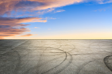 Fototapeta premium Car track square and sky beautiful cloud scenery at sunset