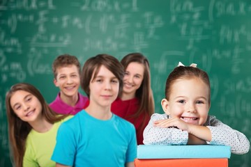 Friendly school children studying concept  on background