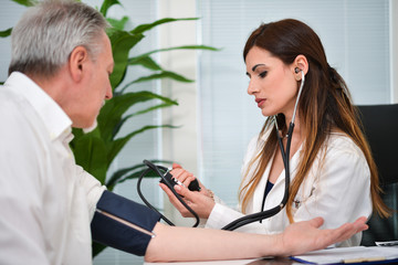 Doctor checking blood pressure