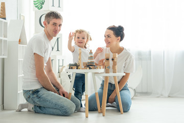the family teaches the child how to play in a large bright room, concept development games, child development, study