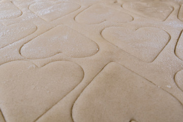 Low Angle Perspective of Hearts Cut Into Cookie Dough