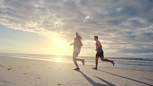 Couple jogging together on the beach