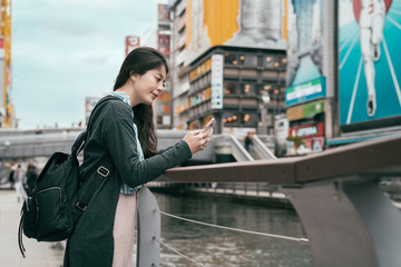 lady traveler using cellphone texting sms message