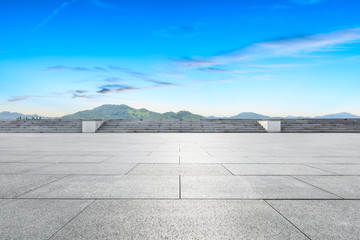 Empty square floor and green mountain scenery