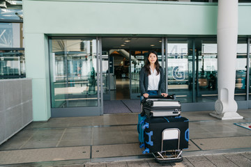 passenger pulling walking with luggage cart