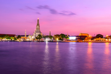 Fototapeta na wymiar Wat Arun Ratchawararam Ratchawaramahawihan with reflections on the river in sunset time
