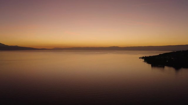 Flying above Lake L&radic;&copy;man with beautiful sunset colors. In front of Cully, Lavaux - Switzerland