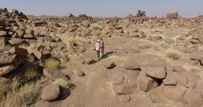 Couple exploring Giants Playground tourist destination, Namibia, AERIAL TRACKING