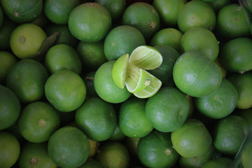 pile of fresh green lemon in market