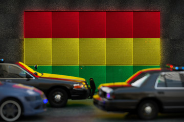 Bright digital display Bolivia flag in city as cars drive past