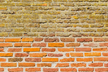 mur de briques anciennes, décapées en bas, non rénovées au-dessus