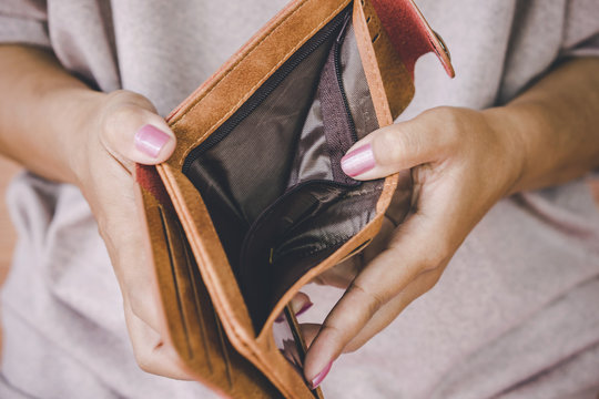 poor woman hand open empty wallet looking for money ,broke ,bankrupt concept 