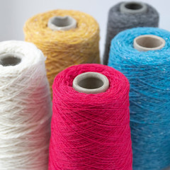 Multi-colored bobbins of wool yarn for hand and machine knitting