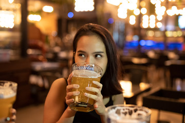 Udon Thani, Thailand - Oct 21, 2018: Hoegaarden beer glass cheers on beautiful girl friends on...