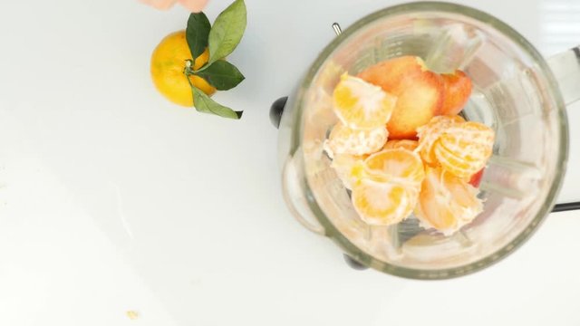mixing ingredients in a blender, for preparation of a fruit cocktail. Top view. Fitness and healthy lifestyle concept. 4K