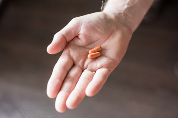 pills in a man's palm