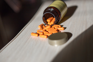 bottle of pills scattered on the table