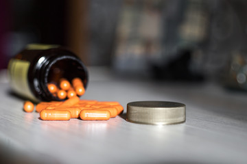 bottle of pills scattered on the table