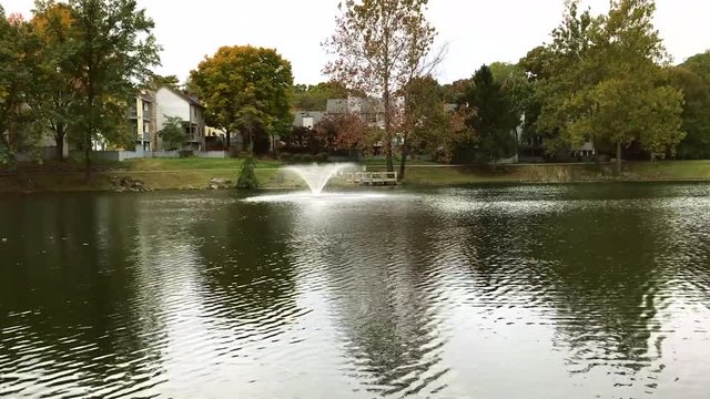 stock footage of a water fountain in a man made pond
