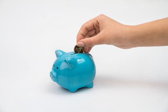 Hand of woman with piggy bank isolated white background