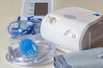 Medical equipment for inhalation with a respiratory mask, a nebulizer and blood pressure measurement. Home portable medical equipment.