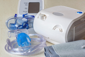 Medical equipment for inhalation with a respiratory mask, a nebulizer and blood pressure measurement. Home portable medical equipment.