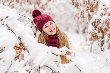 Smiling young woman outdoors in a winter forest