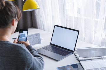 young adult woman at home take a picture of document
