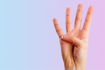 Young woman showing four fingers with hand