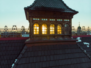 sunset over roof of old european city. winter time