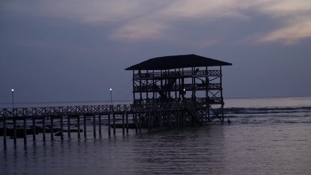 Scenic view of the Cloud9 boardwalk with the sun low and out of frame, silhouetted against a cloudy sky, filmed in UHD 4K