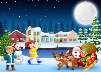 Happy kids with santa claus and elf riding his sleigh at the winter night