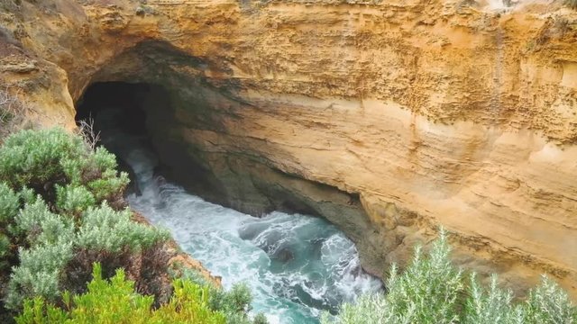 Rapidly fluctuating water level travels through the ocean-carved, Thunder Cave. The Blowhole on Australia's iconic Great Ocean Road.