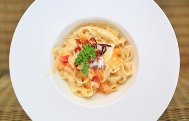 Close-up spaghetti Carbonara on white bowl. Above view.