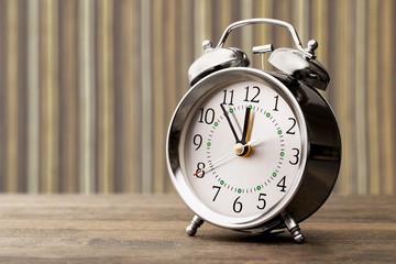 Retro alarm clock on table  background