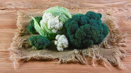 Delicious broccoli and cauliflower has a wooden rustic table. Top view, place for text