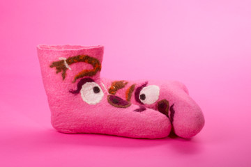 Pink felt socks with a pattern on a pink background