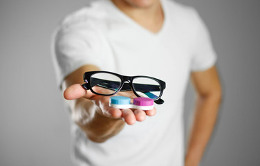 A man holding lenses for eye glasses. Close up. Isolated background