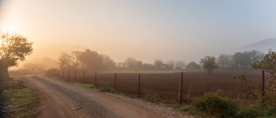 Beautiful autumn landscape in a mountain village. Foggy morning