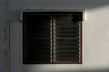 Fototapeta na wymiar The old louver window with hard light